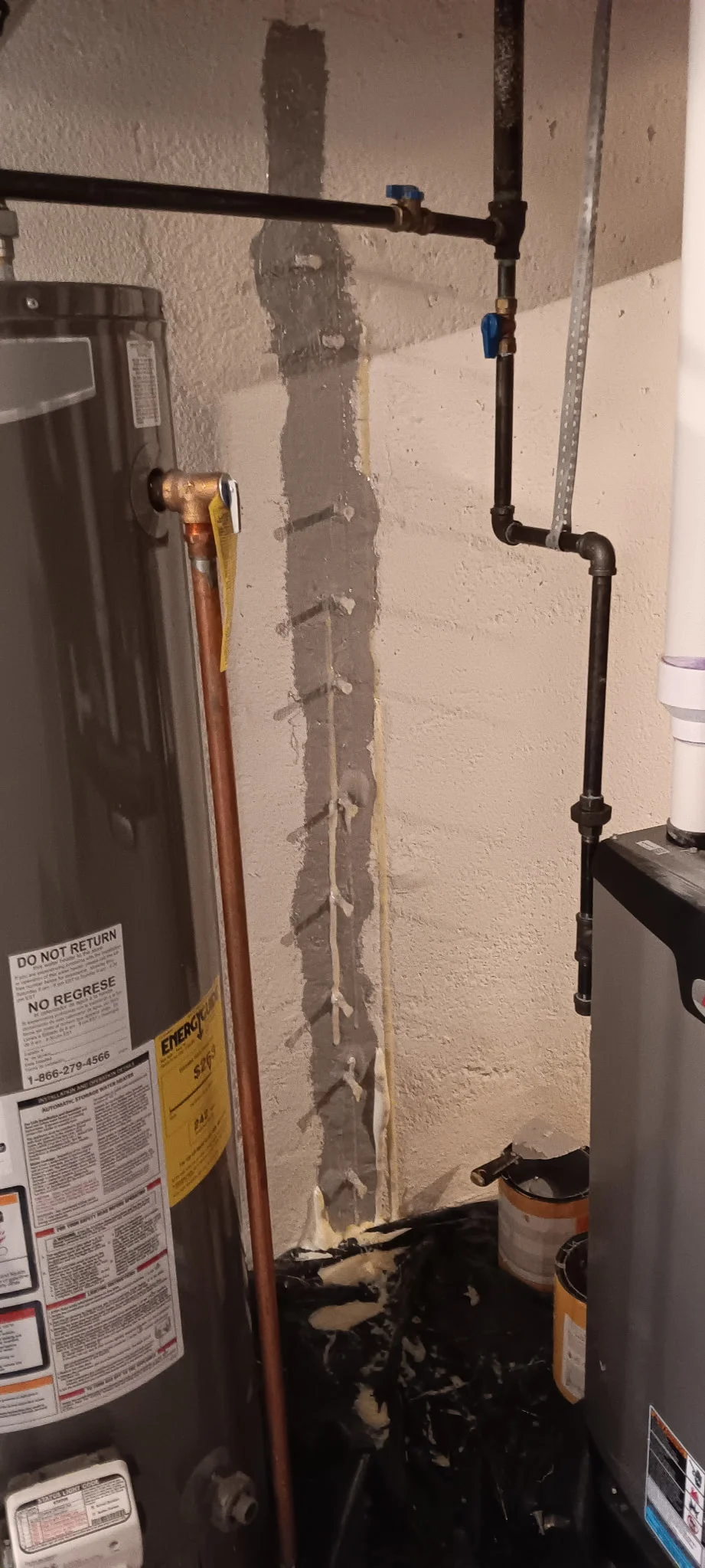 Foundation crack injection repair with injection ports and drainage piping installed on basement wall