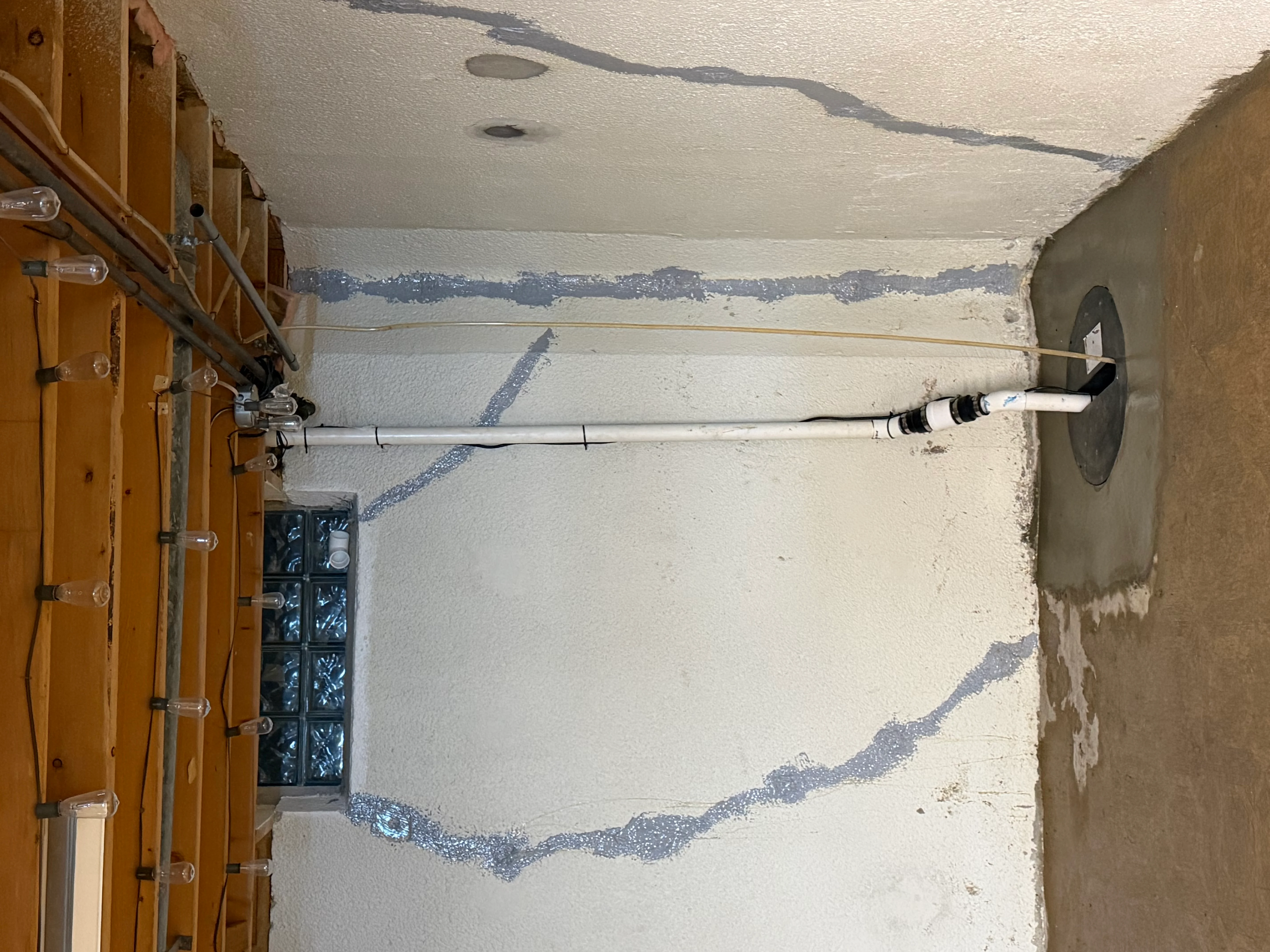 Foundation wall with horizontal crack sealed using polyurethane injection ports and sealant